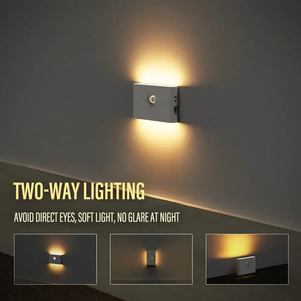 Sleek gray mini motion sensor night light mounted on a wall, casting warm two-way LED light upwards and downwards.
