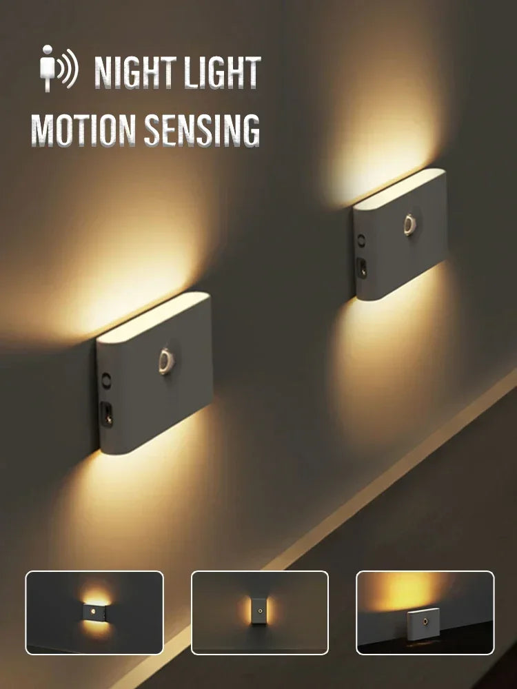 Two rectangular white motion sensor night lights illuminate a wall with warm LED light.